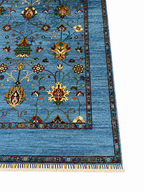 Angled view of the corner of a Chobi Sultani hand-knotted Afghan carpet highlighting the multi-layered geometric border, colorful hand-tied wool fringe, and lustrous sky blue pile — Golden Loom Afghanistan