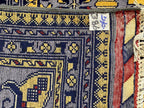 Back view of Belzhiki Afghan hand-knotted carpet showing tight knot density, natural wool fringe, and traditional ZerKhaki border detail – Golden Loom Afghanistan