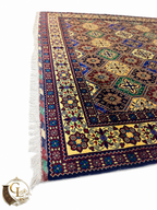 Corner perspective of Belzhiki hand-knotted Afghan carpet — multicolor tile pattern with ivory border and knotted fringe, made to order by women artisans in Jawzjan, Afghanistan