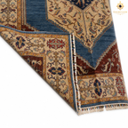 Chobi Kashan Lahori Afghan carpet corner fold showing hand-knotted back — blue medallion, ivory floral border, rust-red field, natural wool with fringe detail
