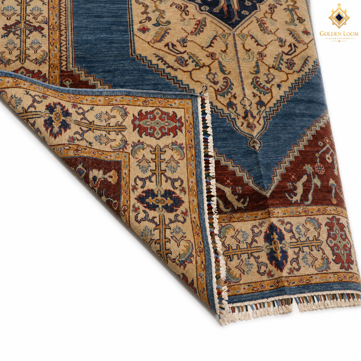 Chobi Kashan Lahori Afghan carpet corner fold showing hand-knotted back — blue medallion, ivory floral border, rust-red field, natural wool with fringe detail