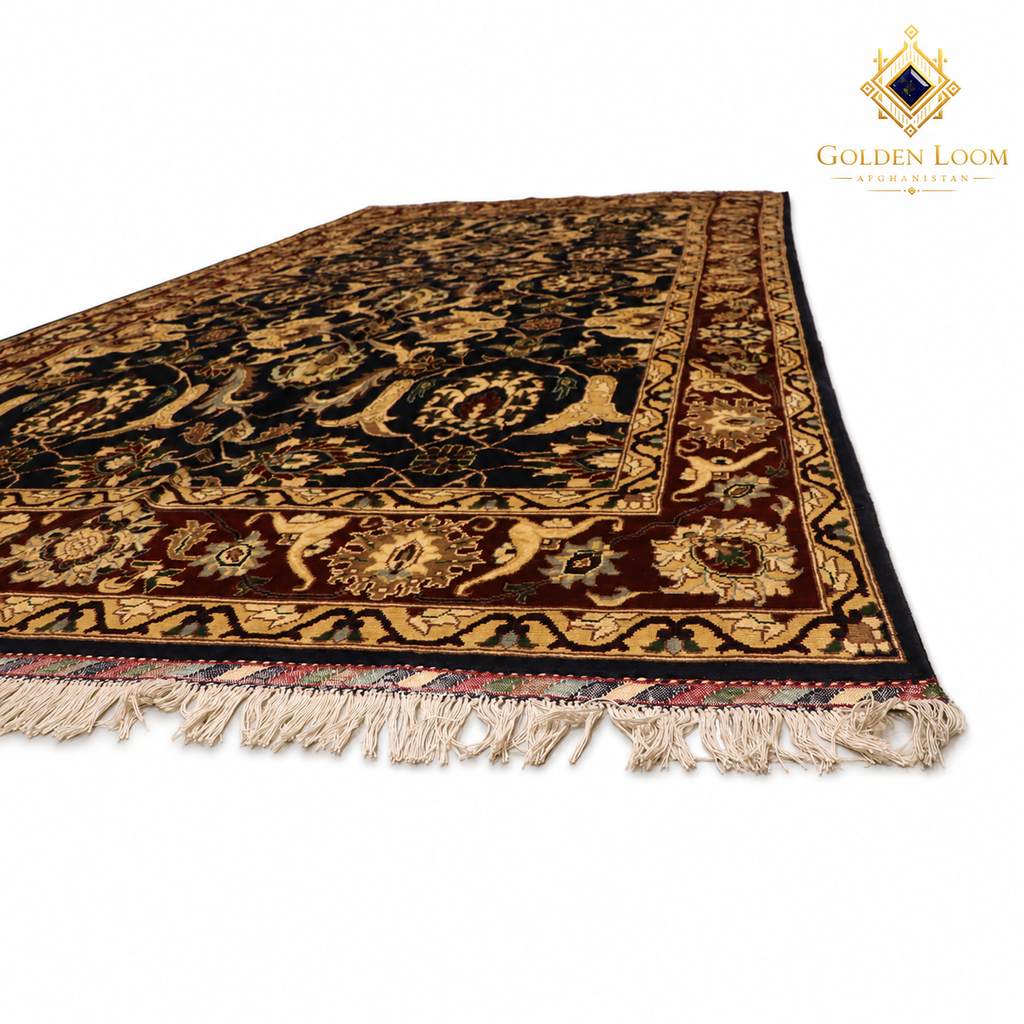 An oriental-style area rug with a dark navy blue and brown base, decorated with intricate gold and beige floral motifs and borders, finished with cream-colored fringe. The Golden Loom brand logo is visible in the top right corner.