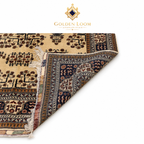 Belzhiki Bokhara Afghan carpet folded to reveal hand-knotted back and ivory field with dark floral border — Golden Loom Afghanistan