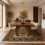 Belzhiki Bokhara Afghan carpet in a contemporary dining room with walnut table, cream chairs, and warm pendant lighting — Golden Loom Afghanistan