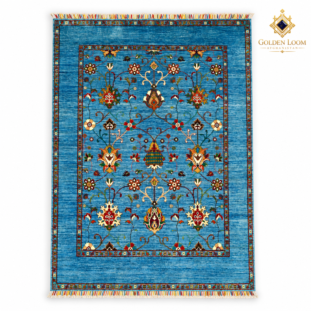 Top view of turquoise hand-knotted Afghan wool carpet with botanical motifs, colourful fringes and Golden Loom Afghanistan logo