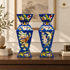 Handcrafted lapis lazuli mosaic vase pair displayed on an elegant walnut console.
