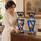 Woman carefully arranging a handcrafted Afghan lapis lazuli mosaic vase pair on a console.