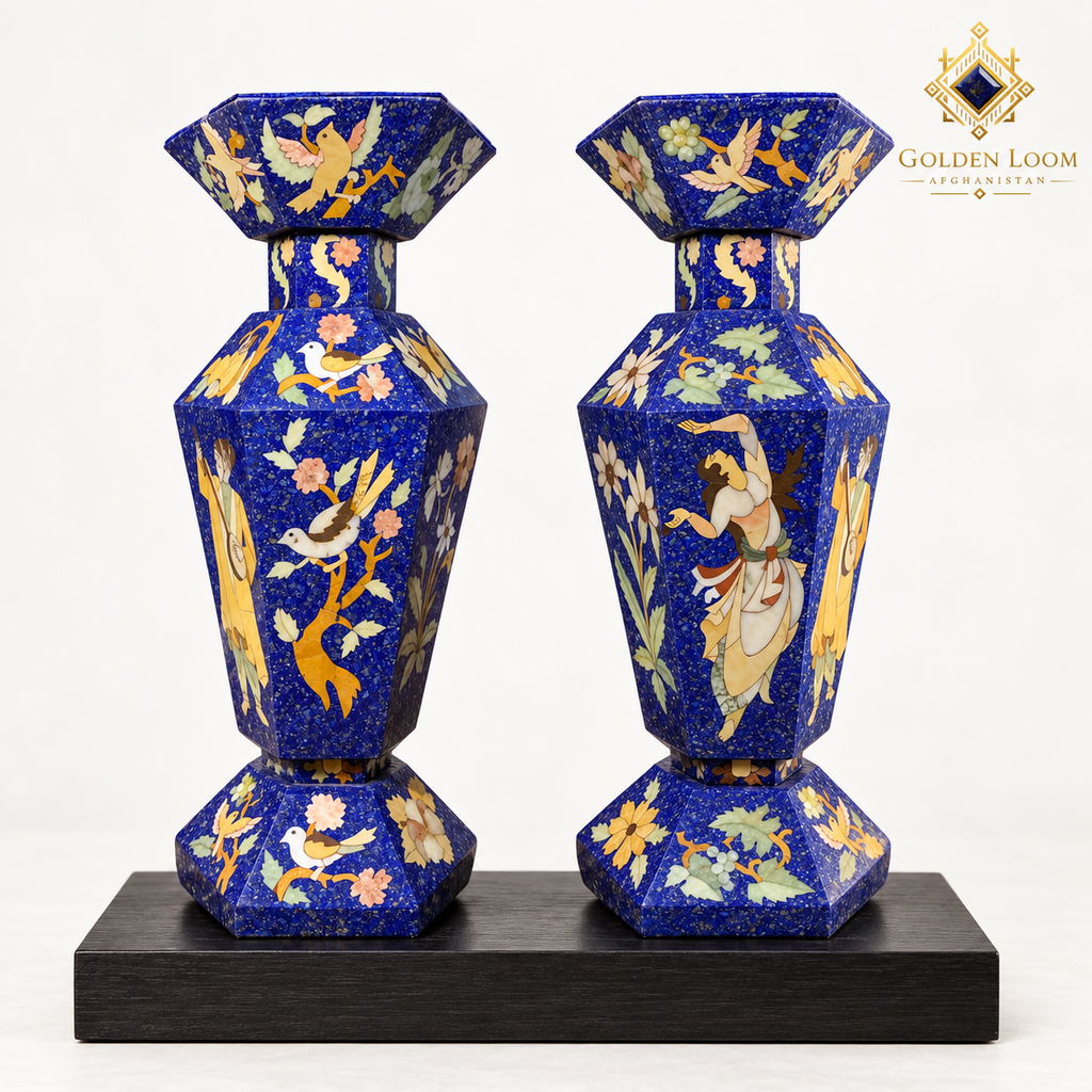Pair of six-sided Afghan mosaic vases with bird, floral and figurative stone inlay displayed on a black wooden plinth