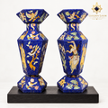 Pair of six-sided Afghan mosaic vases with bird, floral and figurative stone inlay displayed on a black wooden plinth