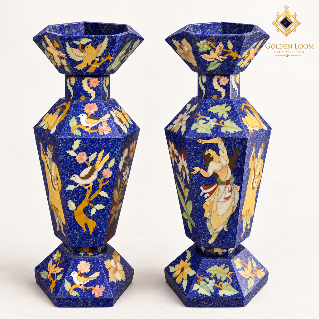 Three-quarter view of two six-sided mosaic vases showing their faceted openings, lapis-chip surfaces and hand-inlaid decorative scenes