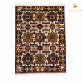 Handwoven Afghan carpet flat lay showing full geometric medallion pattern in ivory, deep red, navy, and gold with fringe border