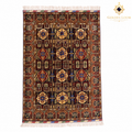 Handwoven Afghan carpet with deep burgundy field, repeating geometric medallion pattern, gold and blue floral motifs, and ivory fringe — Golden Loom Afghanistan