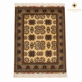 Top view of a hand-knotted Afghan wool carpet with an ivory field, geometric floral motifs and dark patterned borders