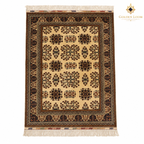 Top view of a hand-knotted Afghan wool carpet with an ivory field, geometric floral motifs and dark patterned borders