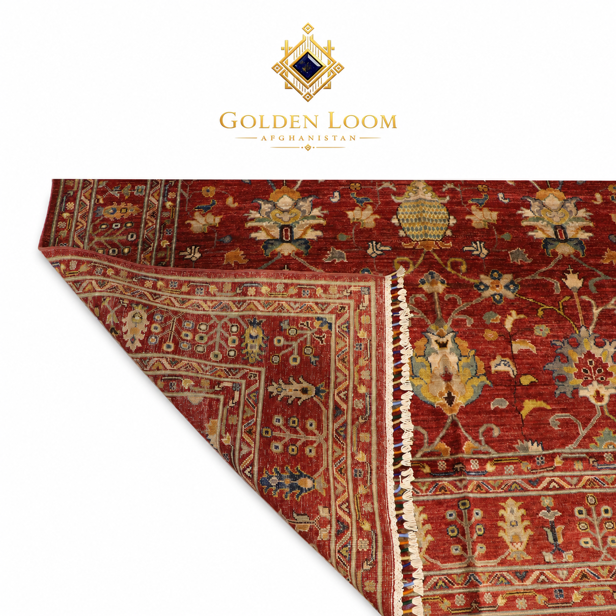 Hand-knotted Afghan Ziegler rug corner fold showing pile depth and woven back, deep red with multicolour floral motifs and ivory fringe — Golden Loom Afghanistan