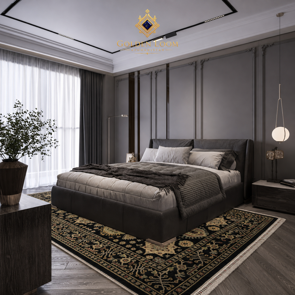 Handmade Afghan wool rug with black and gold traditional motifs placed under a king bed in a contemporary bedroom