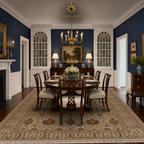 Traditional Afghan floral carpet in ivory and gold under a mahogany dining table in a Colonial American dining room with navy walls and brass chandelier — Golden Loom Afghanistan