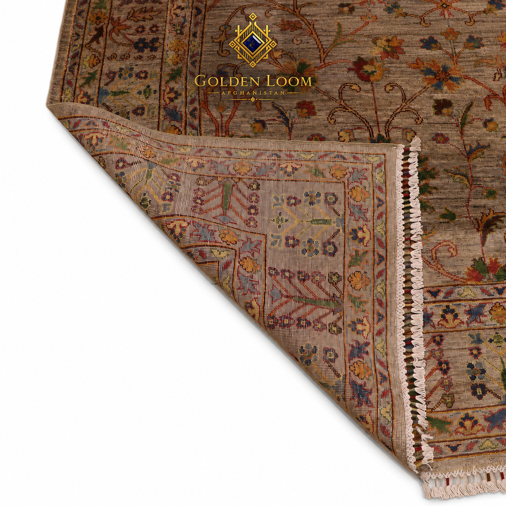 A close-up of a traditional patterned area rug with a folded corner showing the underside and fringe, on a white background. The brand logo 'GOLDEN LOOM' is visible near the top.