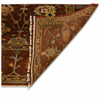 Golden Loom Afghanistan handmade wool rug showing reverse side with ivory fringe, tight knotting, and floral border detail