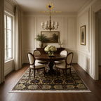 Authentic Afghan carpet with all-over geometric medallion design in ivory and dark charcoal, displayed beneath a round pedestal dining table in an elegant cream-paneled dining room — Golden Loom Afghanistan