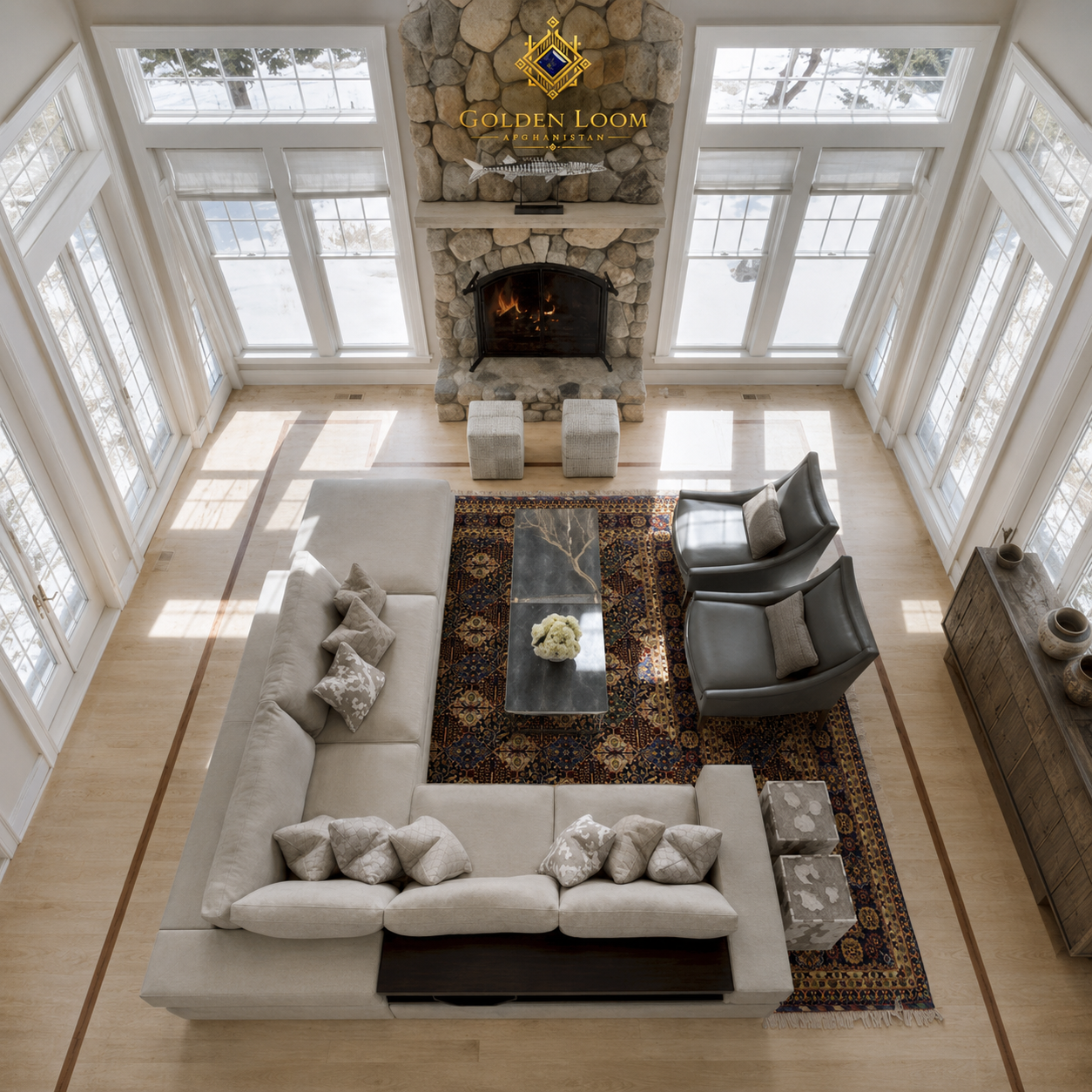 Aerial view of Afghan handwoven rug anchoring a modern living room seating area with stone fireplace and white sectional sofa