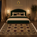 Traditional Afghan hand-knotted carpet with Bokhara medallion design in burgundy and cream, placed in a modern luxury bedroom with emerald green velvet headboard — Golden Loom Afghanistan