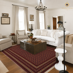 Traditional Afghan hand-knotted carpet in deep crimson with geometric lattice design styled under a tufted white sofa in a classic American farmhouse living room — Golden Loom Afghanistan