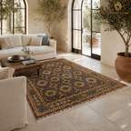 Hand-knotted Afghan rug in slate and antique gold with all-over medallion field styled in a bright Mediterranean-inspired living room with arched steel doors and olive trees — Golden Loom Afghanistan