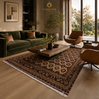 Hand-knotted Afghan area rug with all-over geometric gul pattern in dark brown and cream anchoring a luxury living room with forest green velvet sofa and leather armchairs, Golden Loom Afghanistan