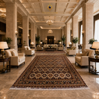 Large hand-knotted Afghan carpet with all-over medallion pattern in dark burgundy and ivory displayed in a grand hotel lobby with marble floors and crystal chandeliers, Golden Loom Afghanistan