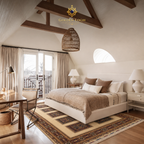 Afghan hand-knotted panel rug in ivory and warm brown placed beneath a white upholstered bed in a bright farmhouse bedroom with exposed timber beams and wicker pendant light — Golden Loom Afghanistan