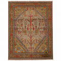 Handwoven Afghan tree-of-life carpet on white background, featuring intricate botanical motifs in red, gold, and sage on a warm beige field with tassel fringe