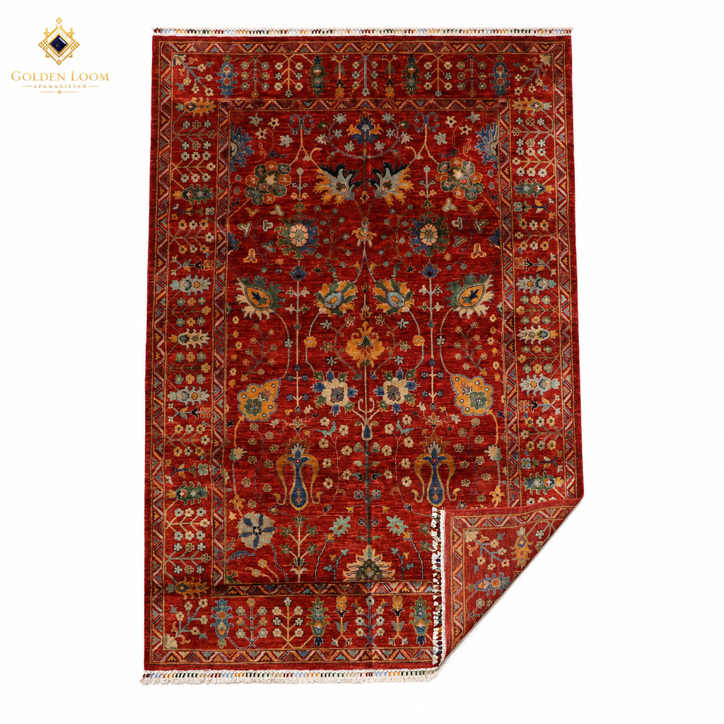 Hand-knotted Afghan Chobi rug in crimson red with all-over floral vine pattern, corner folded to show wool pile and fringe detail — Golden Loom Afghanistan