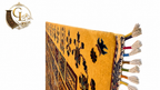 Corner edge detail of Afghan Chobi rug showing golden wool pile, dark tribal motifs, and multicolor knotted fringe tassels – hand-knotted in Mazar-i-Sharif, Afghanistan"