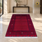 Red hand-knotted Afghan wool carpet displayed in a bright luxury entrance gallery