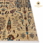 Close view of a golden-beige Afghan carpet with colourful tree motifs and hand-finished fringe