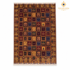 Top view of brown hand-knotted Afghan carpet with framed botanical motifs and fringe on two short ends