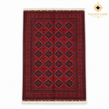 Top view of a red Khal Mohammadi hand-knotted Afghan wool carpet with dark geometric motifs and white fringe.