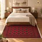 Red Khal Mohammadi Afghan wool carpet styled beneath a walnut bed in a warm, light-filled bedroom.