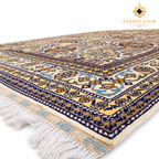 Close-up of an Afghan wool carpet with cream, navy, gold and blue geometric floral motifs