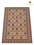 Afghan area rug with a cream background, colorful floral medallions, intricate geometric motifs, and a richly patterned border