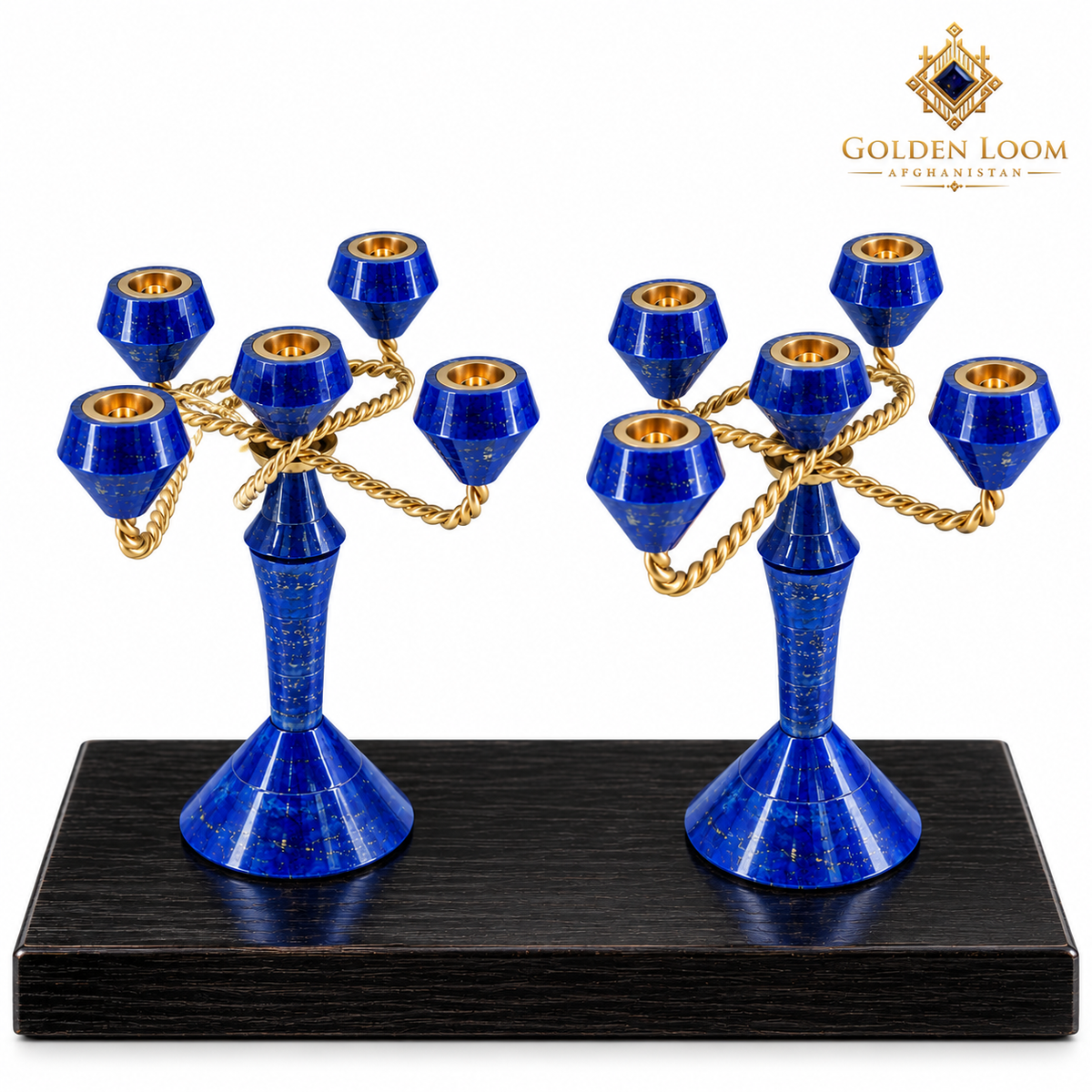 A pair of five-arm gold and lapis lazuli crystal candelabras displayed on a black wooden base against a white background, with the Golden Loom brand logo in the top right corner.