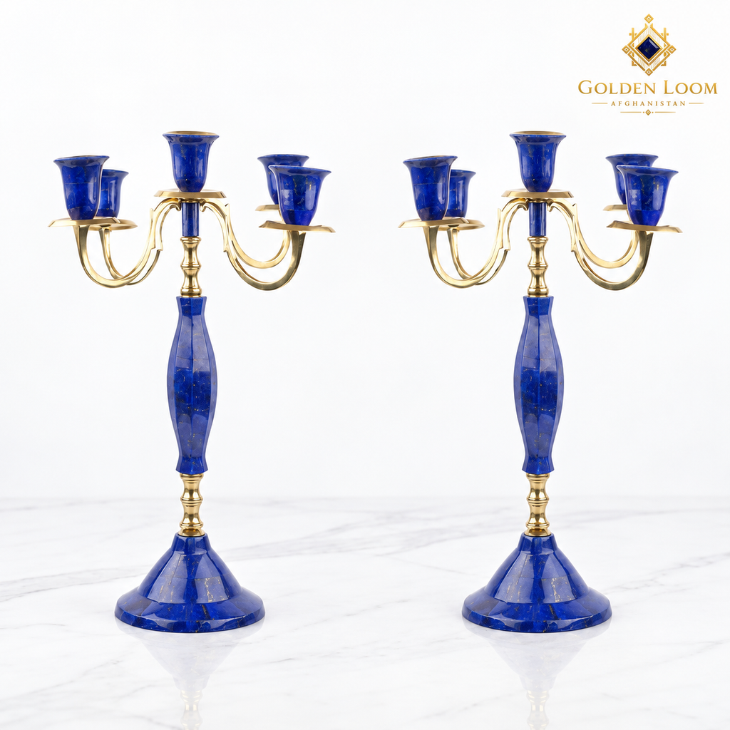 Pair of handcrafted five-arm lapis lazuli and brass candelabra on a white marble background.