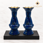 Pair of handcrafted lapis lazuli vases with brass-lined scalloped rims displayed on black wood against a white background.