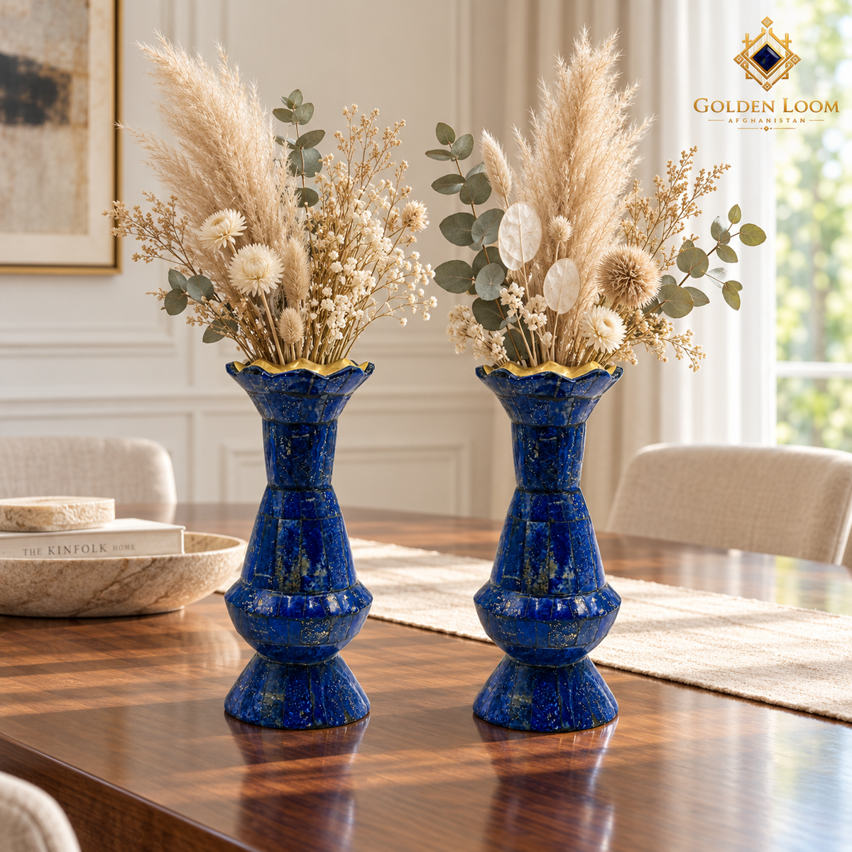 Matching lapis lazuli vase pair displayed symmetrically on a walnut console in an elegant neutral interior.