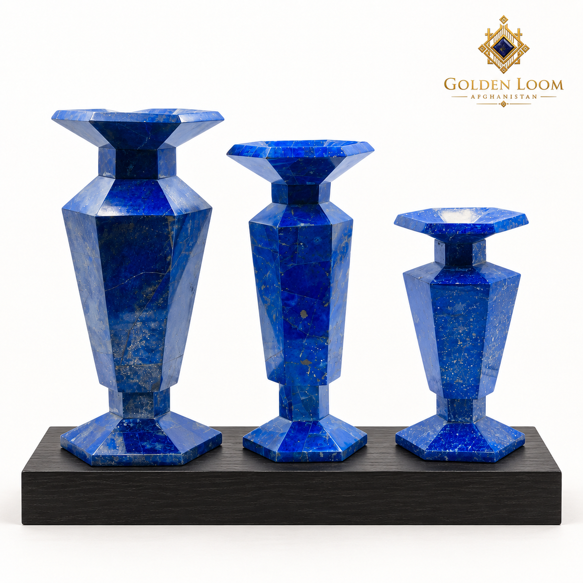 Three graduated six-sided lapis lazuli vases displayed on black wood against a clean white background.
