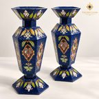 Elevated three-quarter view of two six-sided Afghan mosaic vases showing their faceted openings, floral stone inlay and lapis surfaces