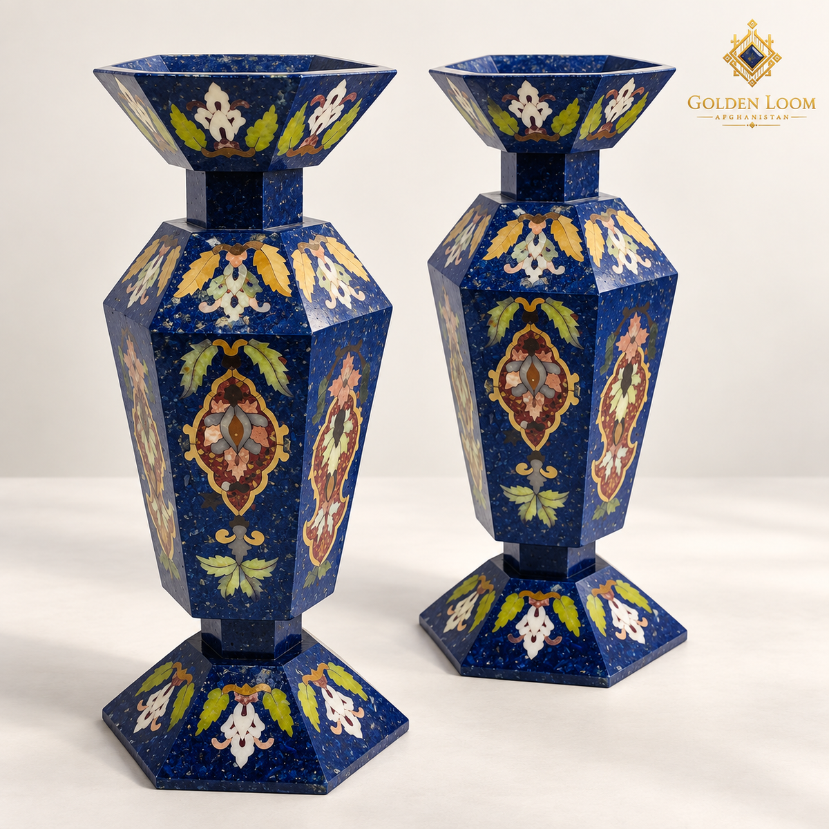 Elevated three-quarter view of two six-sided Afghan mosaic vases showing their faceted openings, floral stone inlay and lapis surfaces