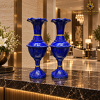 Lapis lazuli vase pair displayed on a dark marble console in a luxury hotel lobby.