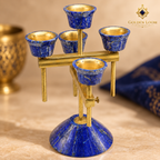 Close-up of genuine lapis lazuli candle cups with natural pyrite markings and hand-finished brass details.